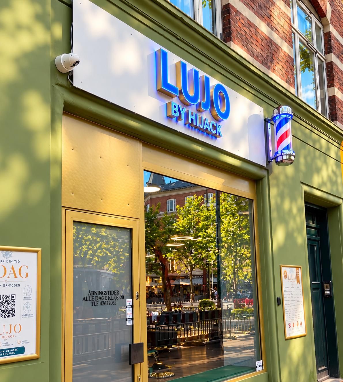 Facaden på LUJO by Hijack ved Enghave Plads med det blå skilt og barberstangen